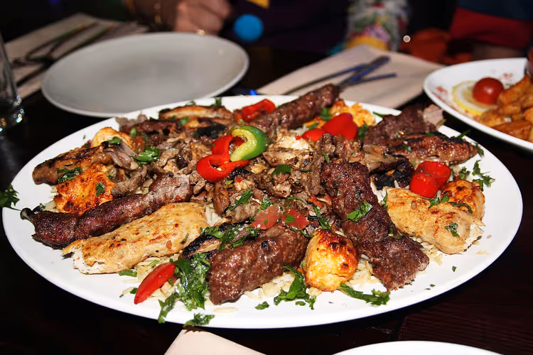 Plate with assorted grilled meat and vegetables