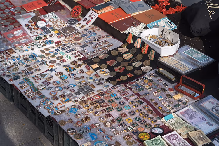 Flea market stall with badges and banknotes