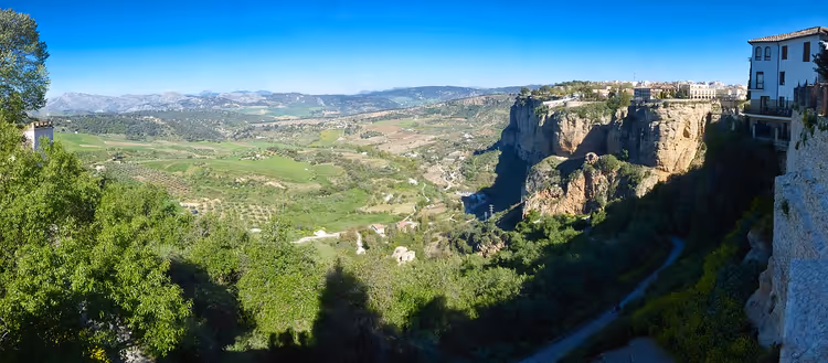 Ronda'nın evleriyle yeşil vadi ve kayalıkların görünümü