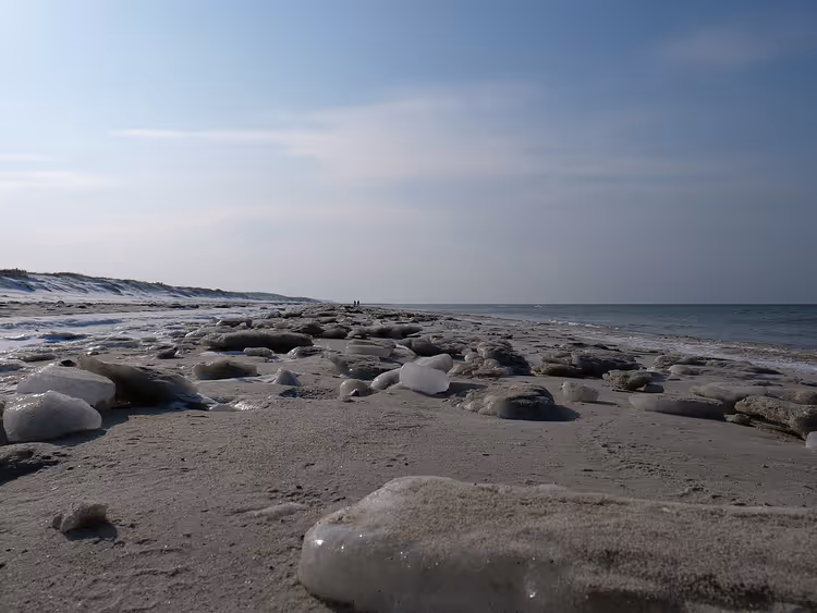 Praia vazia do Mar Báltico no inverno com blocos de gelo