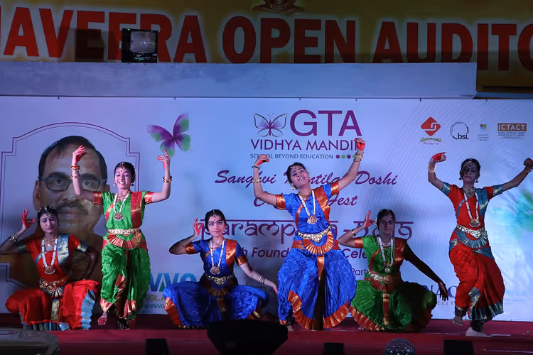 Dansers in kostuum voeren Bharatanatyam op het podium op
