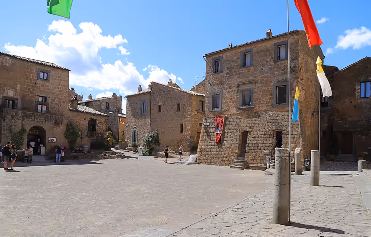 Piazza San Donato avec ses maisons en pierre et ses drapeaux