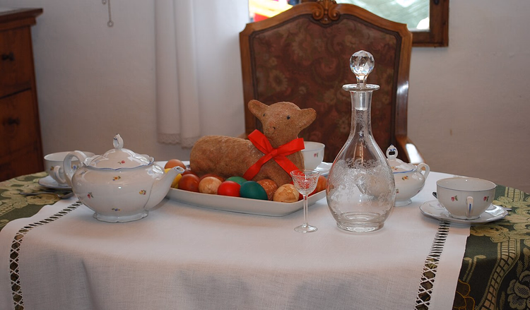 Paaslamtaart en geverfde eieren op een tafel