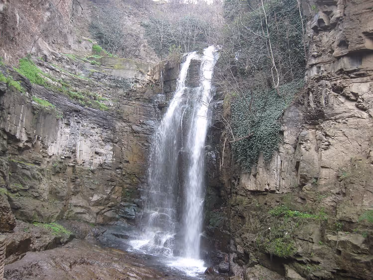Leghvtakhevi Waterfall in a rocky canyon among greenery