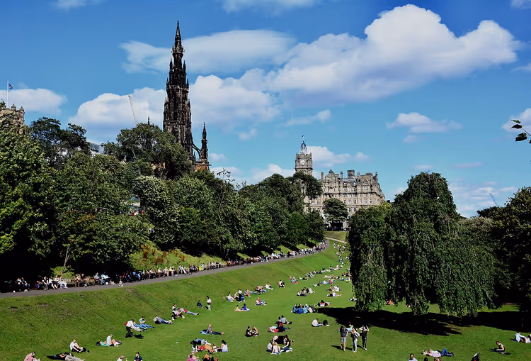 People relaxing on the lawn in Princes Street Gardens