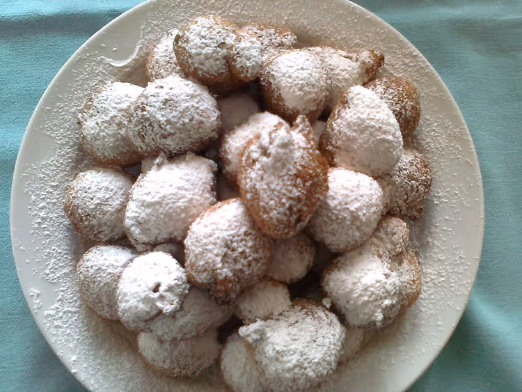 Sweet fritule balls with powdered sugar