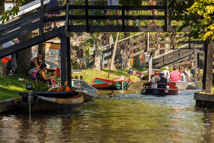 Båter på en kanal i Giethoorn nær en trebro
