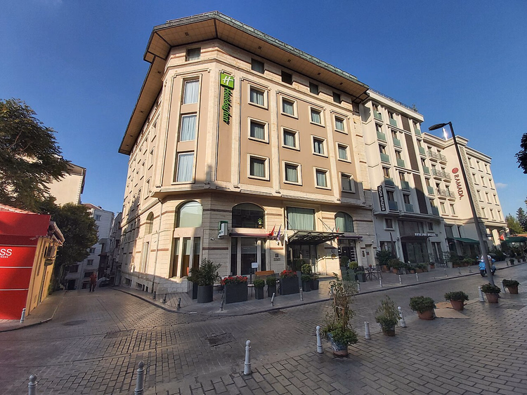 Фасад отеля Holiday Inn на мощёной улице
