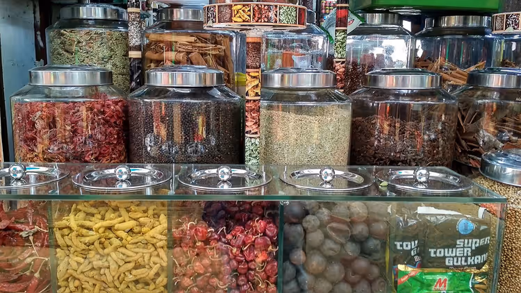 Vitrinekast met potten specerijen op een markt