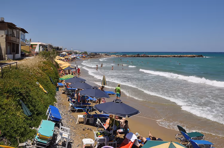 Strand met parasols en ligbedden aan zee