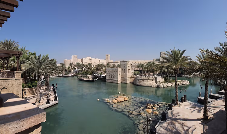 Kanaal van Madinat Jumeirah met bootjes en palmbomen