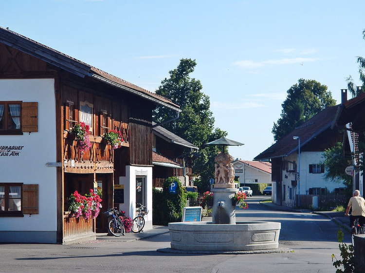 Straat met een fontein in het centrum van Schwangau