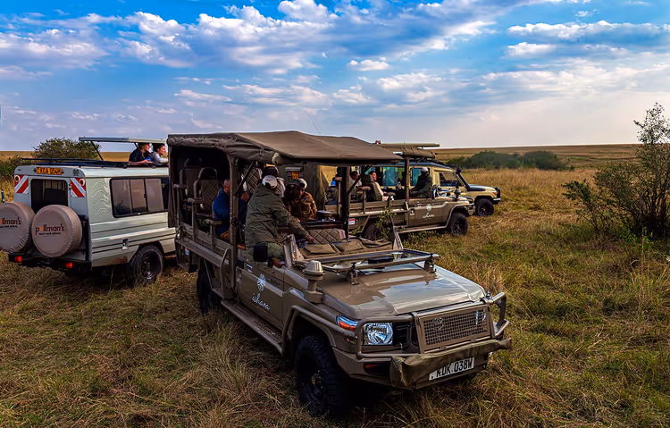 Safarijeeper med turister på Maasai Mara-savannen