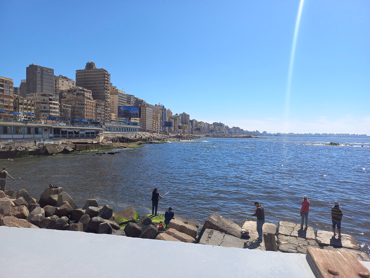 Alexandria corniche with fishermen on the breakwaters