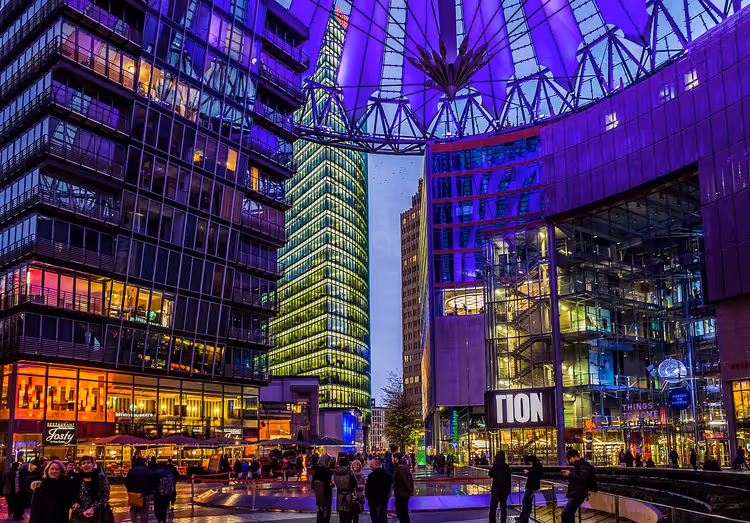 Sony Center ночью со светящейся стеклянной крышей в Берлине
