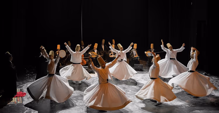 Whirling Mevlevi dervishes performing sema on stage