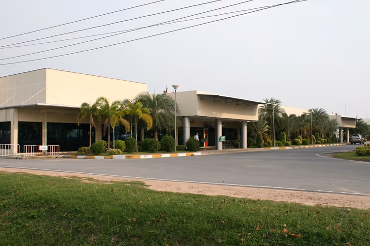 Terminal des Flughafens U-Tapao mit Palmen und einer Straße