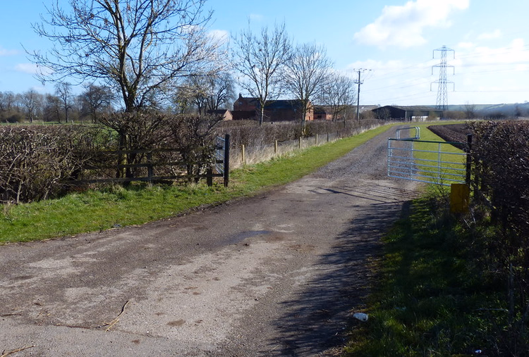 Landweggetje dat naar een boerderij op het Engelse platteland leidt