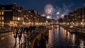Illustration: Feuerwerk über einer Amsterdamer Gracht bei Nacht, Menschenmenge auf beleuchteter Backsteinbrücke vor Giebelhäusern