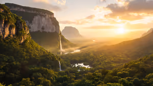 Wasserfall stürzt bei Sonnenaufgang von einem steilen Tafelberg in den Regenwald, Nebel liegt über einem Fluss in Canaima