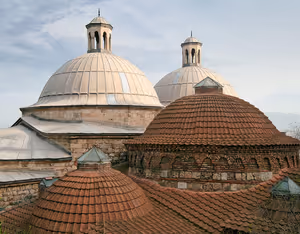 Mit Blei gedeckte und rot geziegelte Kuppeln mit kleinen Laternentürmchen auf einem alten steinernen Badehaus in der Türkei