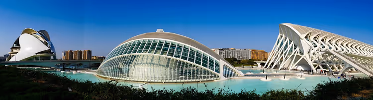 Futuristische weiße Gebäude der Stadt der Künste und Wissenschaften in Valencia an türkisfarbenen Wasserbecken unter klarem Himmel