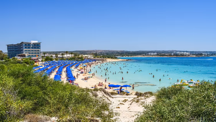 Callisto Hotel ve şemsiyelerle Makronissos Plajı