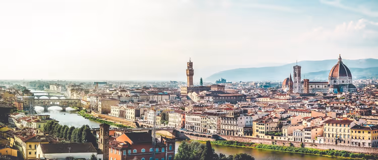 Panorama von Florenz mit der Domkuppel, dem Turm des Palazzo Vecchio und Brücken über den Arno in dunstigem Licht