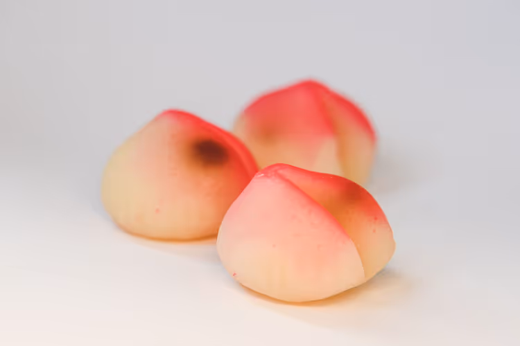 Three peach cookies with a pink blush