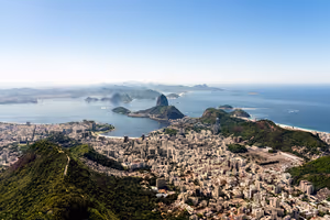 Rio de Janeiro von oben mit dichten Häuserblocks, grünen Hügeln, dem Zuckerhut und der Guanabara-Bucht