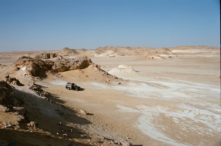 SUV driving through the rocky Farafra Desert