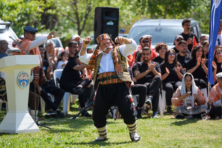 Eldre mann i tyrkisk drakt som danser under en feiring
