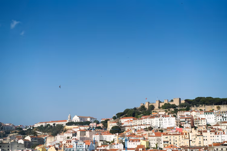 Colina antiga de Lisboa com telhados e uma fortaleza