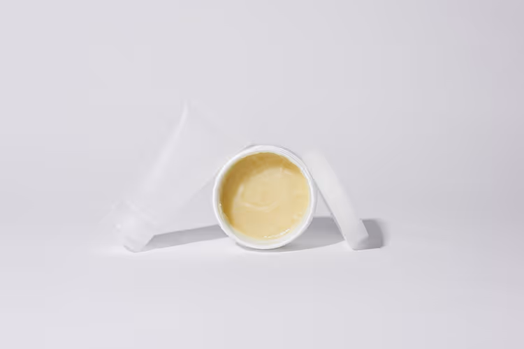 White tubes and a jar of yellow ointment