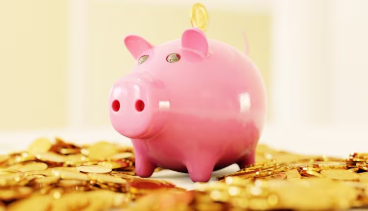 pink pig coin bank on brown wooden table