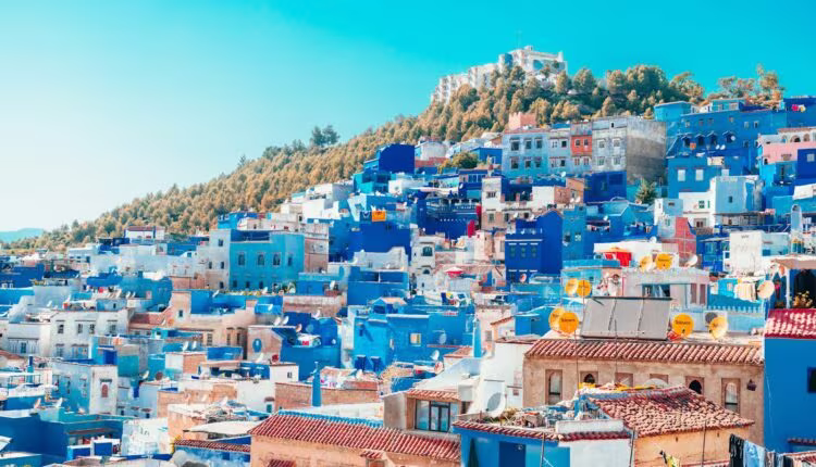 blue and white painted houses on the cliff