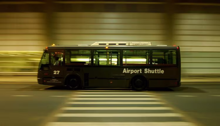 red and black bus on gray road