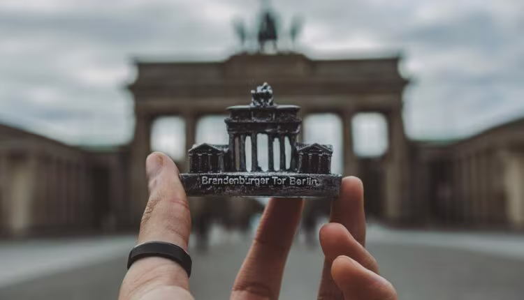 person holding black and white miniature building