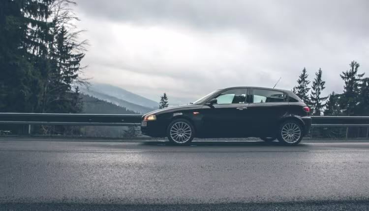 black car near road rails