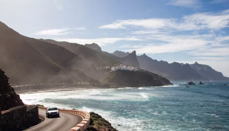 white car passing through road