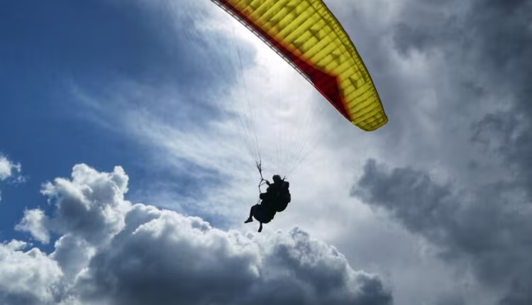 a person in the air with a parachute