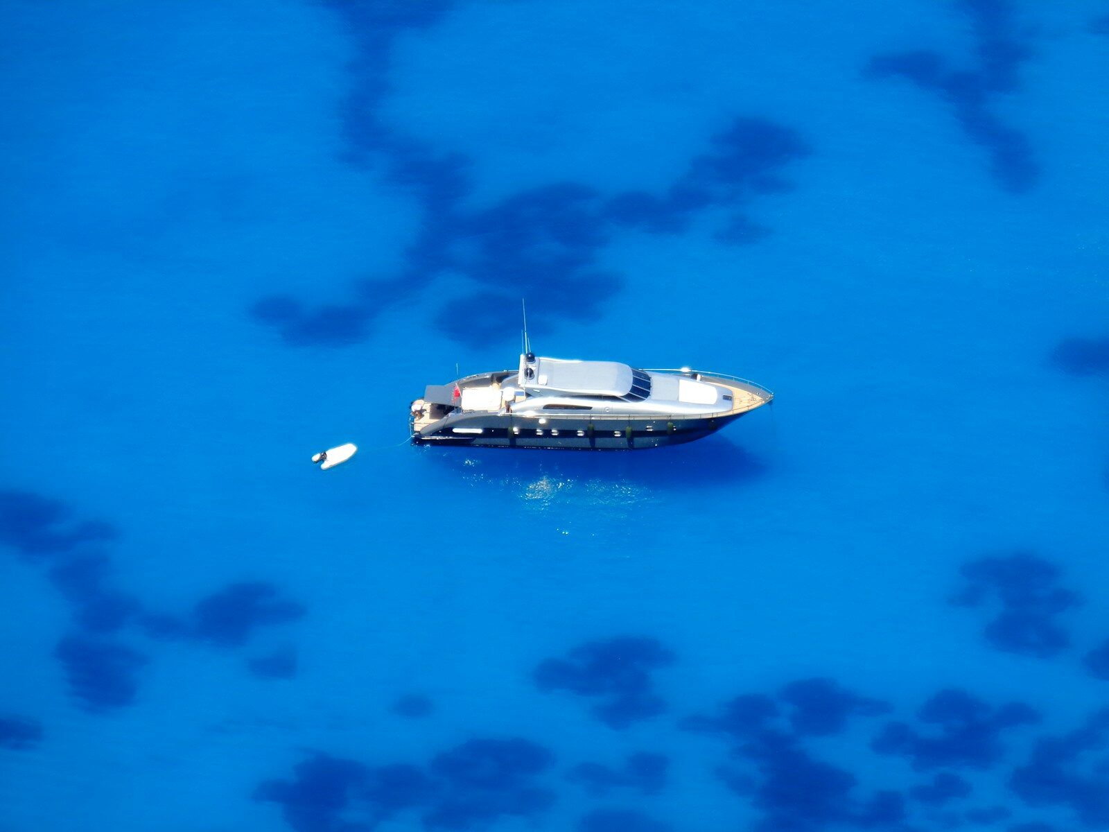 Greece yacht charter, Ionian sailing, Greek islands 📸📸 Photorealistic sailing yacht anchored in a crystal-clear Ionian bay near a green Greek island, white limestone shoreline, warm late-afternoon sunlight, calm sea, elegant travel photography, natural colors 📸📸 Sailing yacht in the Greek Ionian Islands