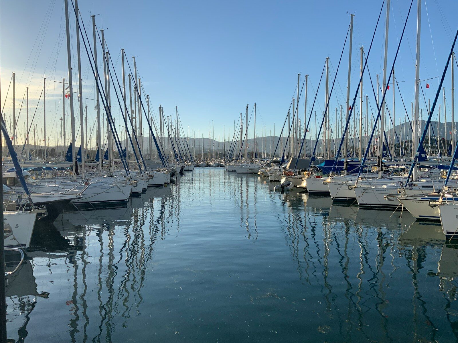 Greek yacht charter preparation, sailing skipper, Lefkada marina 📸📸 Photorealistic experienced skipper checking lines and navigation equipment aboard a modern sailing yacht in a Lefkada marina, early morning sunlight, calm Ionian water, authentic nautical details, premium travel photography 📸📸 Skipper preparing a sailing yacht in Greece
