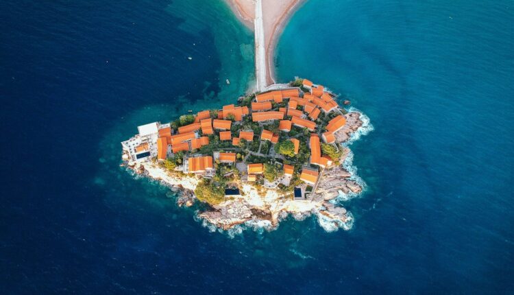 aerial view of city buildings near body of water during daytime